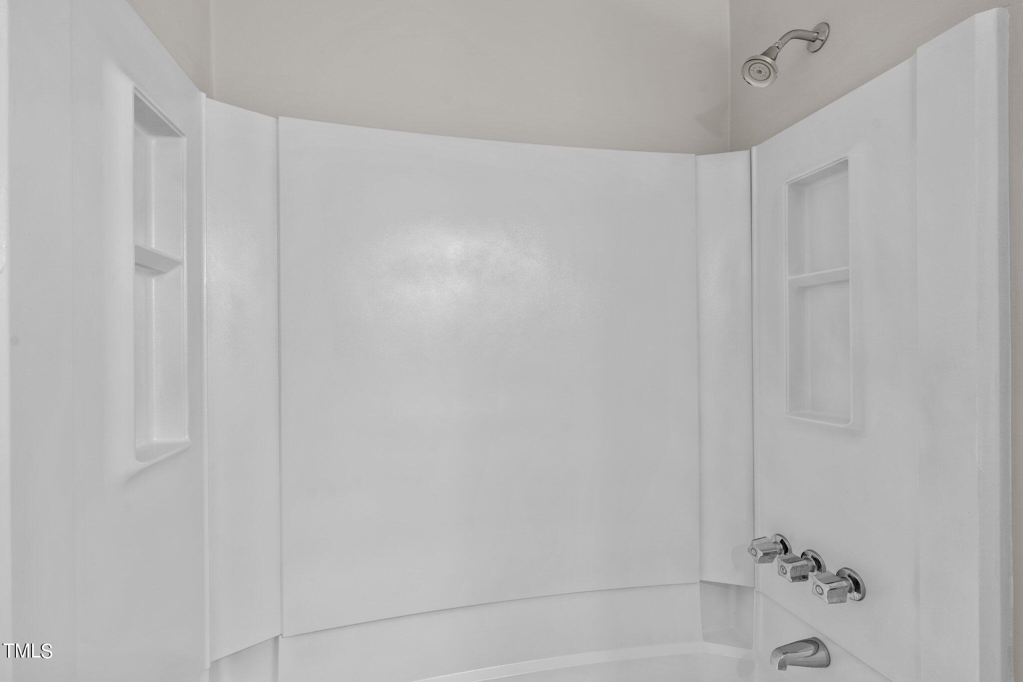 3408 Comstock Road Raleigh, NC 27604 - Photo 18 of 33 a bathroom with a shower and a bath tub