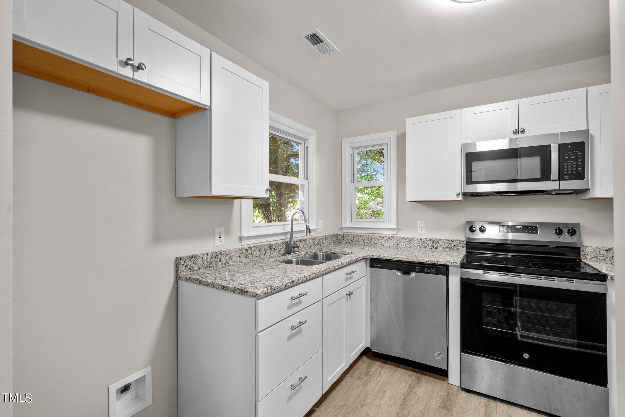 3408 Comstock Road Raleigh, NC 27604 - Photo 2 of 33 a kitchen with stainless steel appliances granite countertop a sink and stove top oven
