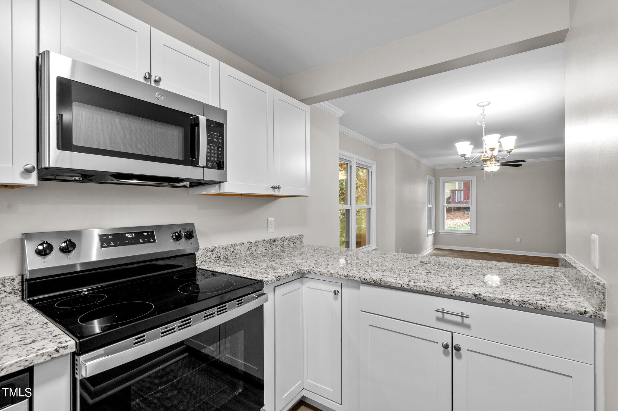 3408 Comstock Road Raleigh, NC 27604 - Photo 4 of 33 a kitchen with a stove and a microwave
