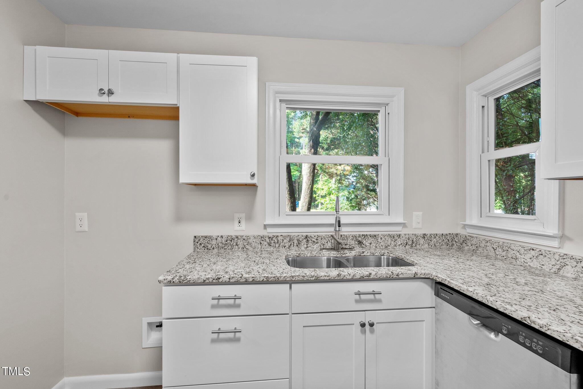 3408 Comstock Road Raleigh, NC 27604 - Photo 5 of 33 a kitchen with stainless steel appliances granite countertop white cabinets and a window