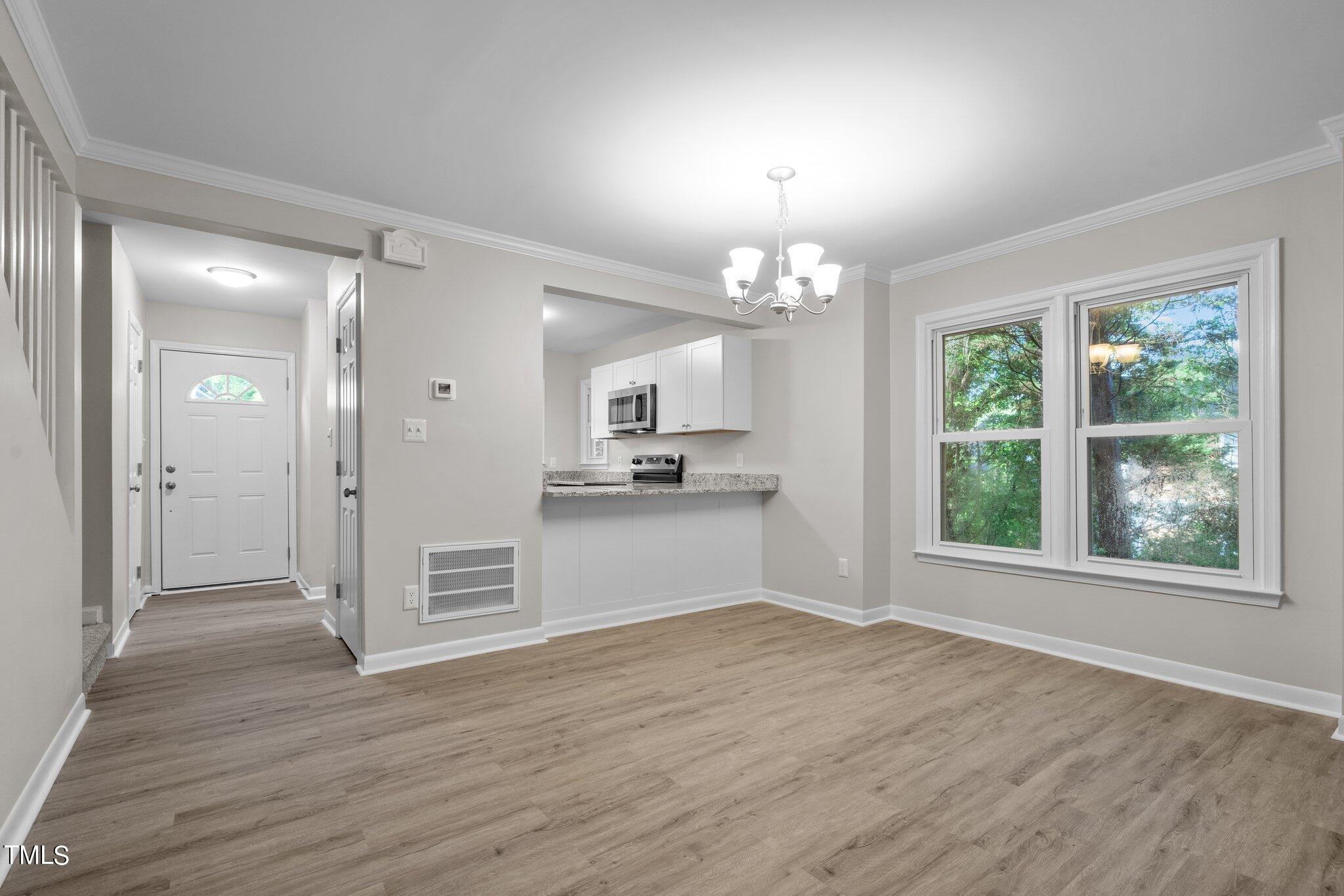 3408 Comstock Road Raleigh, NC 27604 - Photo 7 of 33 a view of a kitchen with a sink and dishwasher with wooden floor