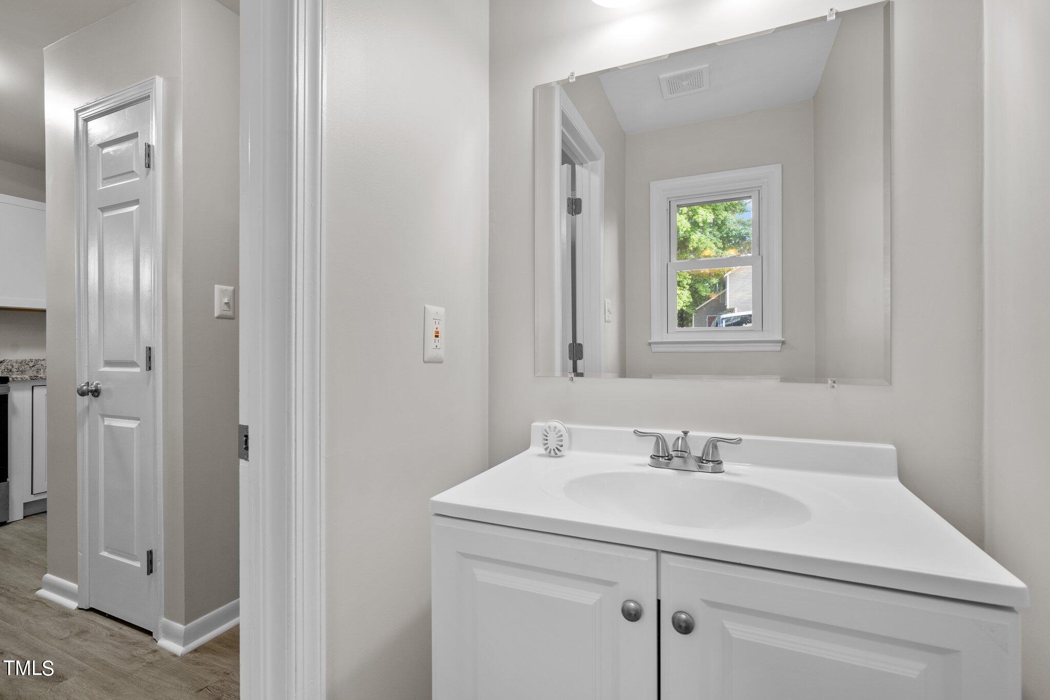 3408 Comstock Road Raleigh, NC 27604 - Photo 10 of 33 a bathroom with a sink and a mirror
