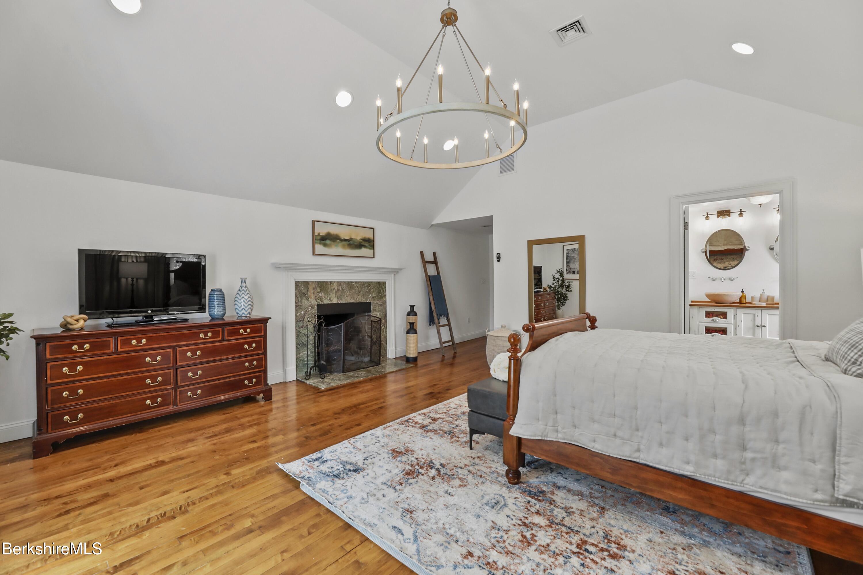 1 Devon Road Stockbridge, MA 01262 - Photo 17 of 58 a spacious bedroom with a bed and wooden floor