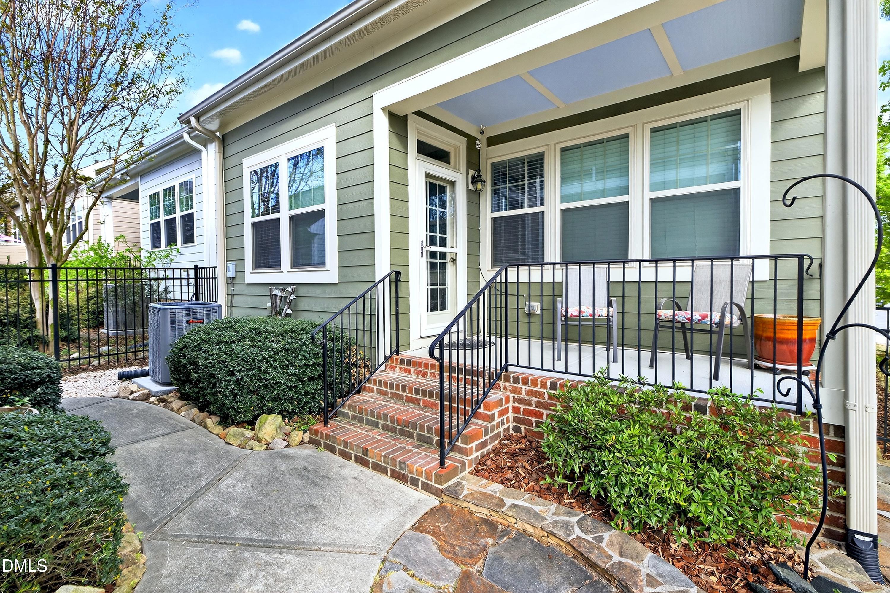2025 Great Ridge Parkway Chapel Hill, NC 27516 - Photo 11 of 61 front view of a house with a bench next to a yard