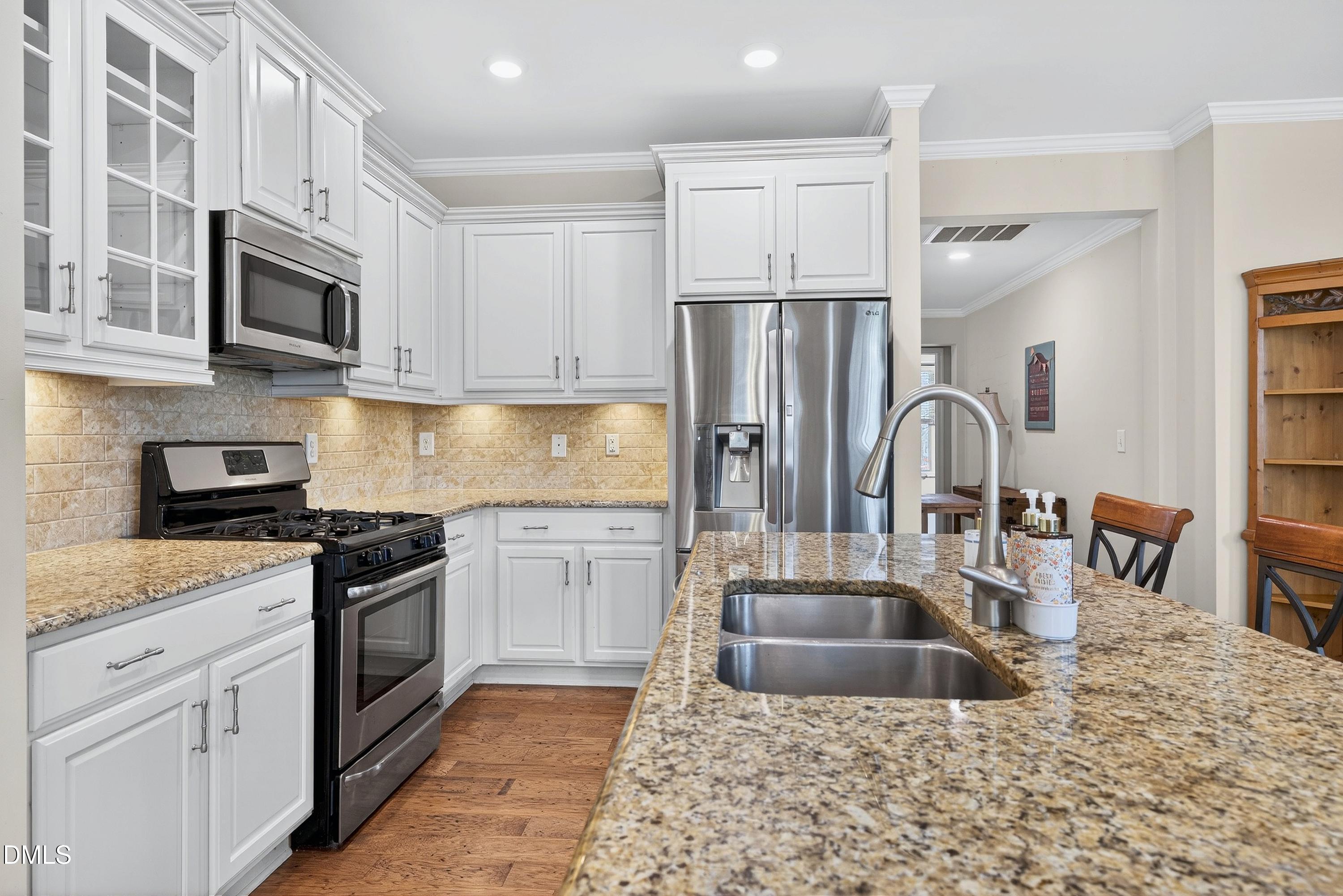 2025 Great Ridge Parkway Chapel Hill, NC 27516 - Photo 20 of 61 a kitchen with stainless steel appliances granite countertop a refrigerator a stove top oven a sink and dishwasher