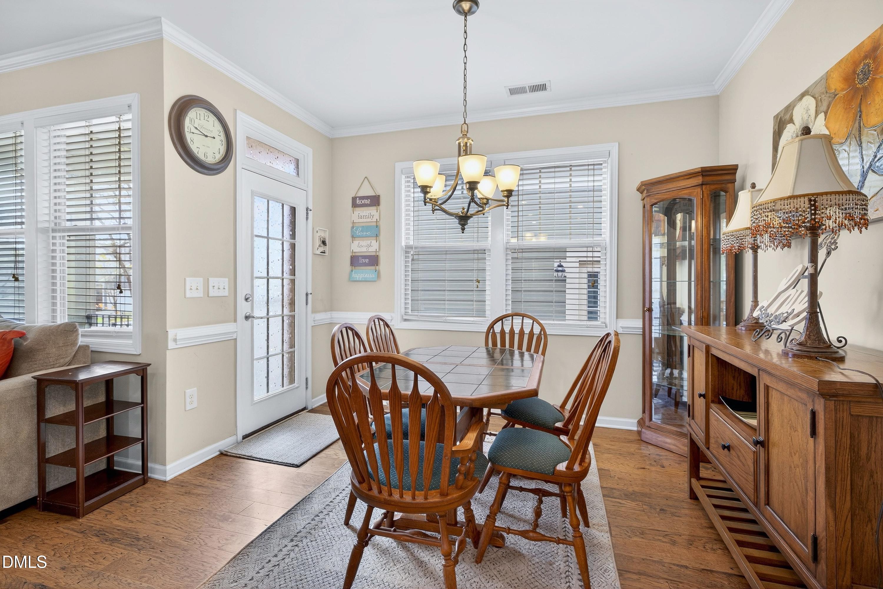 2025 Great Ridge Parkway Chapel Hill, NC 27516 - Photo 21 of 61 a dining room with furniture a chandelier and wooden floor