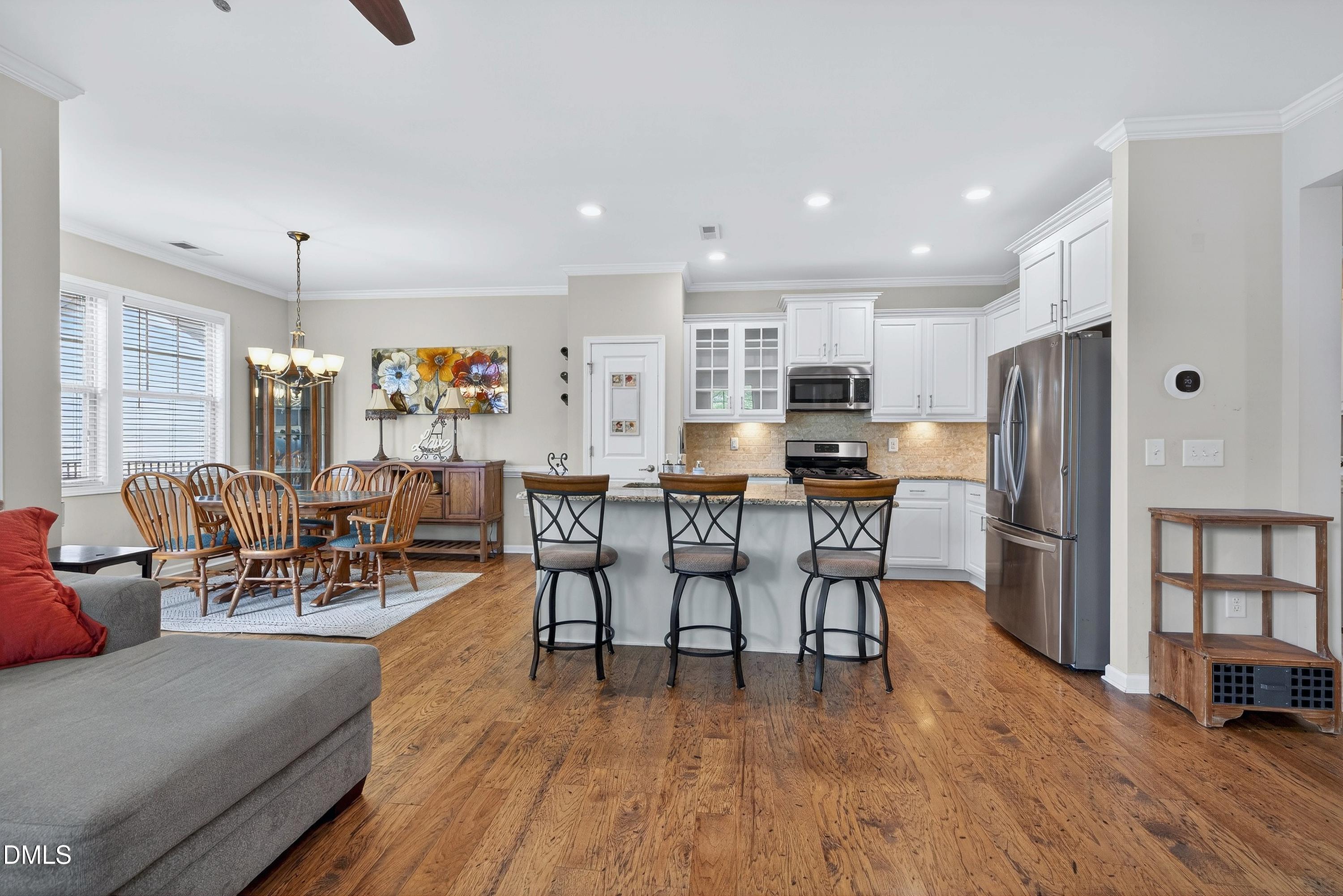 2025 Great Ridge Parkway Chapel Hill, NC 27516 - Photo 3 of 61 a living room with stainless steel appliances furniture and a wooden floor