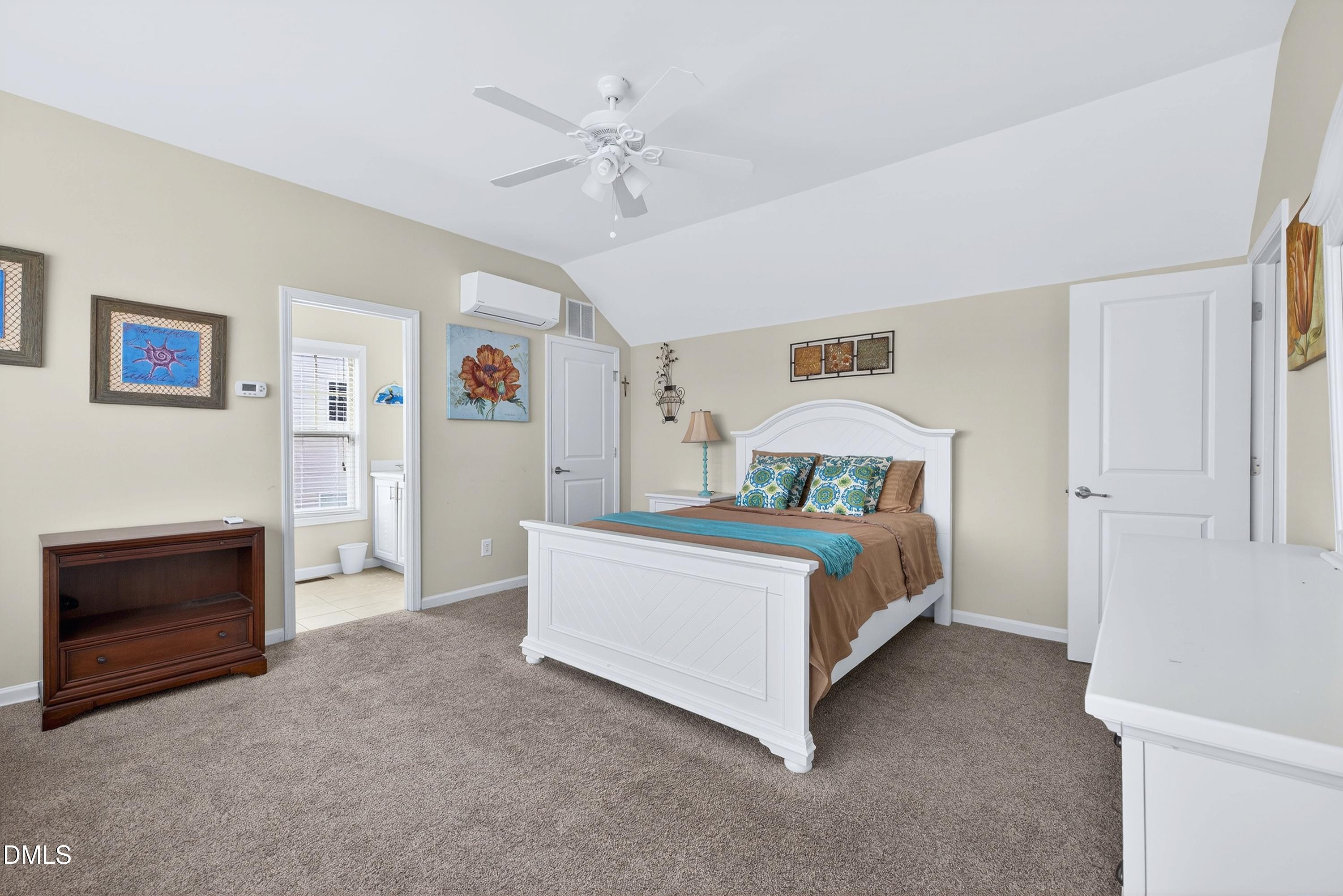 2025 Great Ridge Parkway Chapel Hill, NC 27516 - Photo 40 of 61 a bed room with a bed and a chandelier