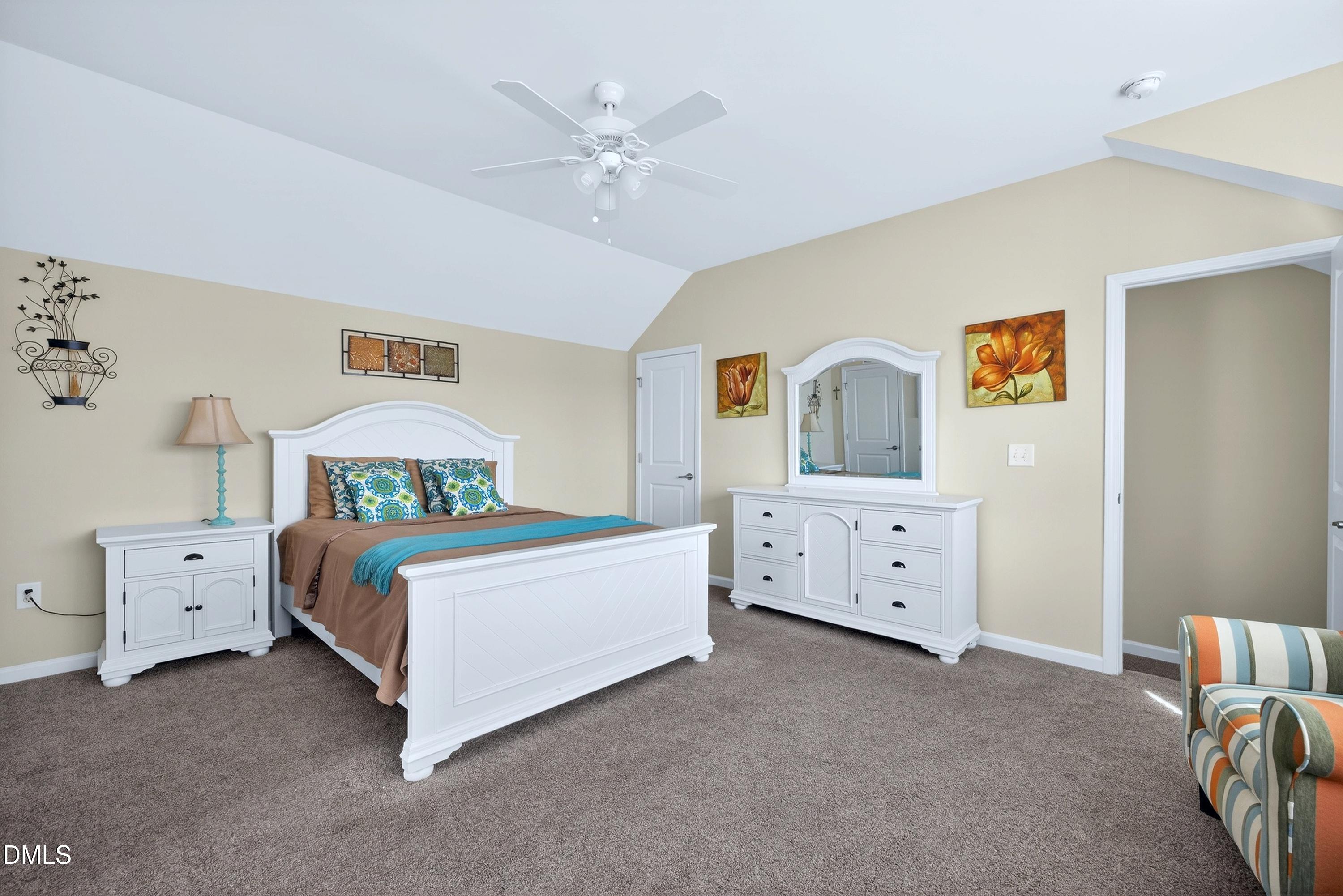2025 Great Ridge Parkway Chapel Hill, NC 27516 - Photo 41 of 61 a room with a bed and a chandelier
