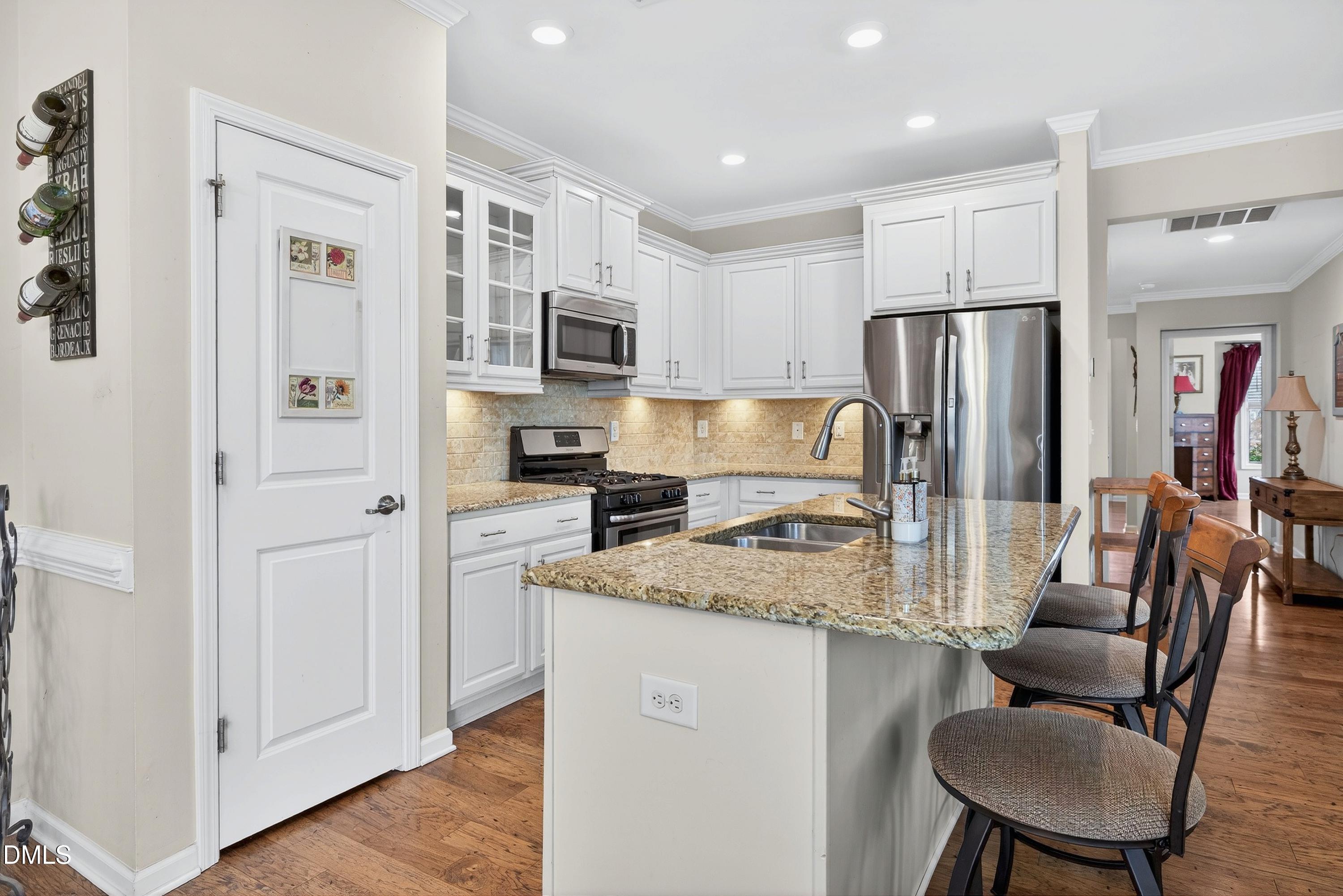 2025 Great Ridge Parkway Chapel Hill, NC 27516 - Photo 5 of 61 a kitchen with stainless steel appliances granite countertop a refrigerator a stove a sink a dining table and chairs
