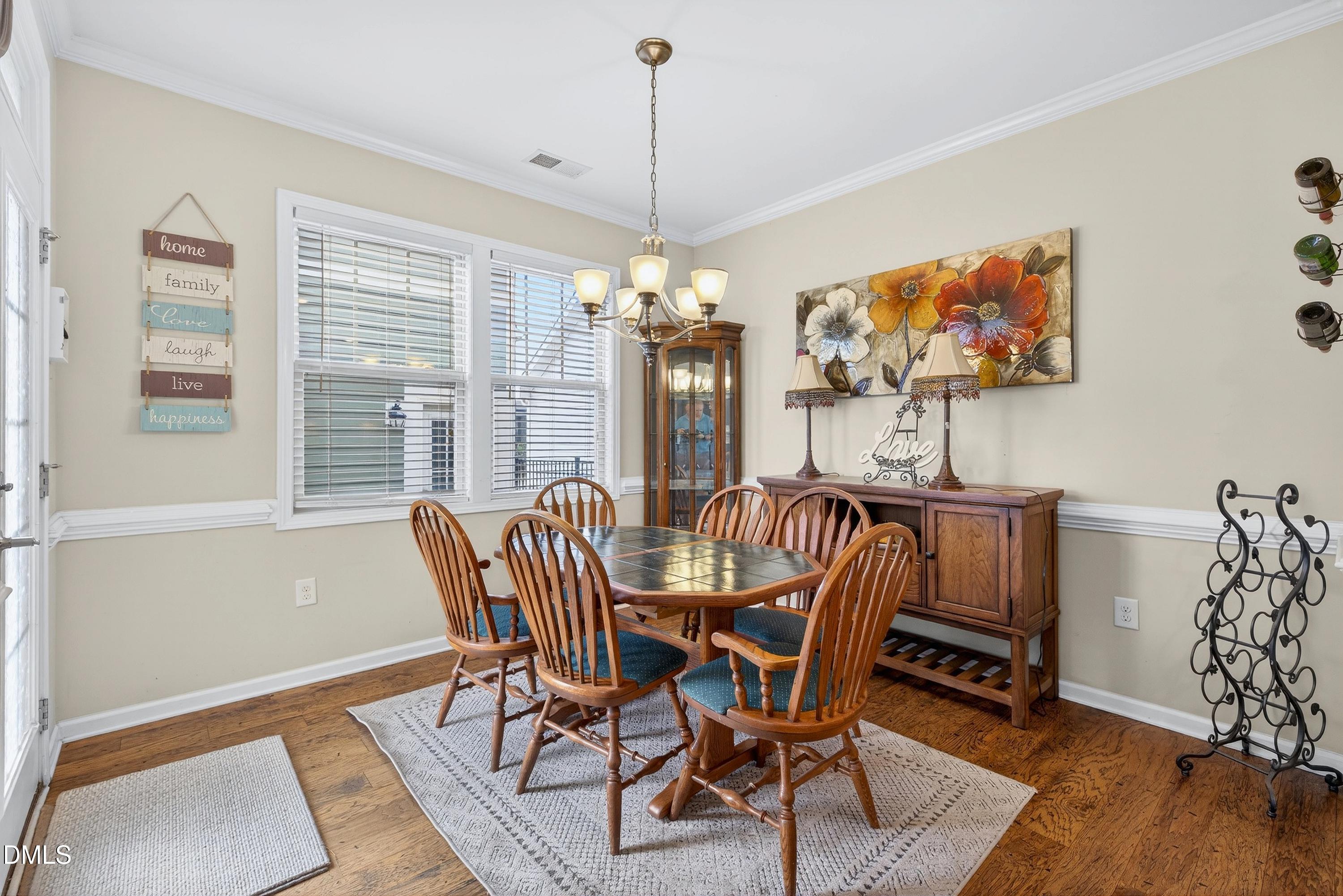 2025 Great Ridge Parkway Chapel Hill, NC 27516 - Photo 7 of 61 a view of a dining room with furniture wooden floor and chandelier