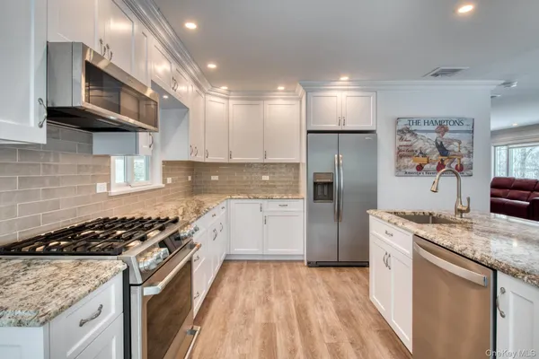 a kitchen with a stove a refrigerator and a sink