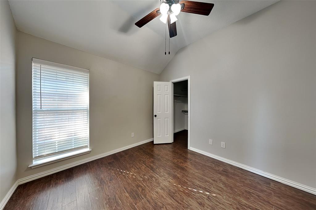 7641 Lancelot Road Frisco, TX 75035 - Photo 12 of 21 an empty room with wooden floor fan and windows