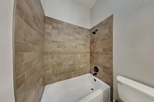 a bathroom with a bathtub and a toilet