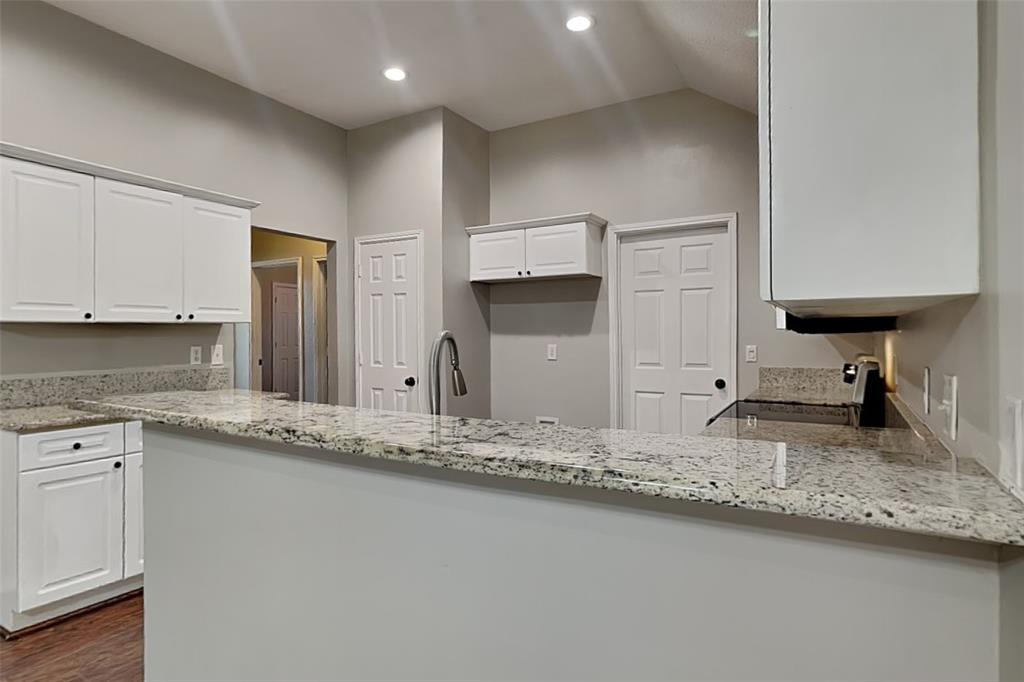 7641 Lancelot Road Frisco, TX 75035 - Photo 4 of 21 a kitchen with granite countertop a sink a stove and a refrigerator
