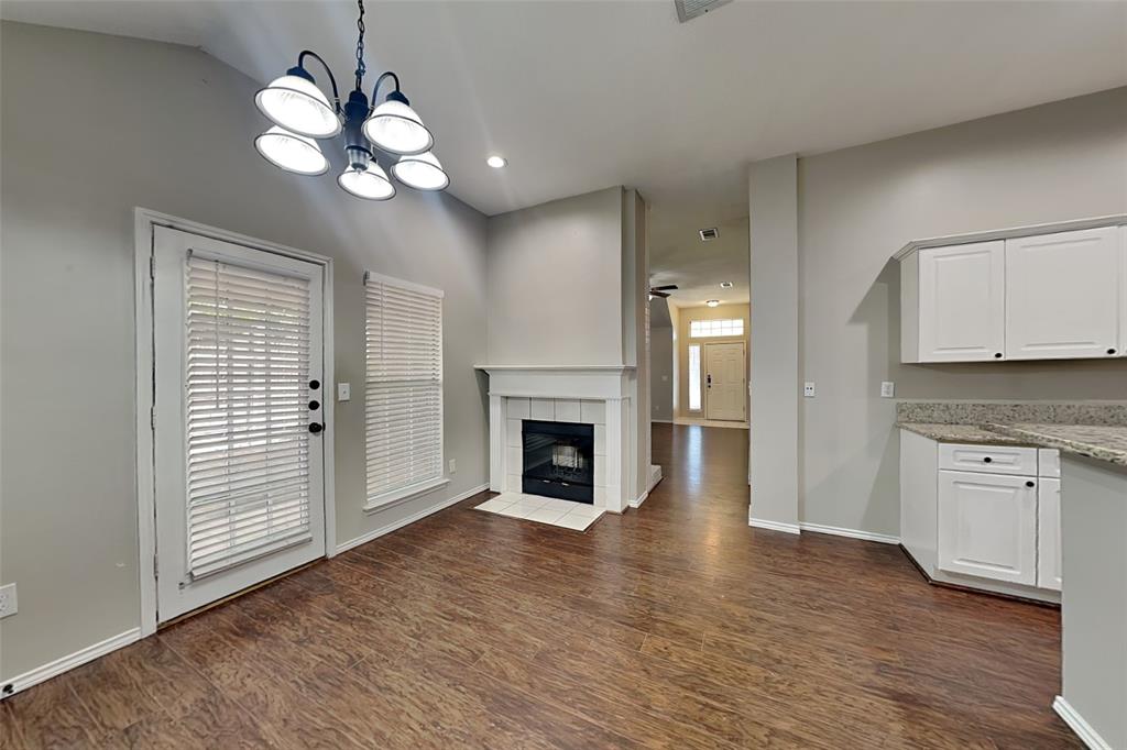7641 Lancelot Road Frisco, TX 75035 - Photo 6 of 21 a view of a kitchen with a fireplace cabinet and a window