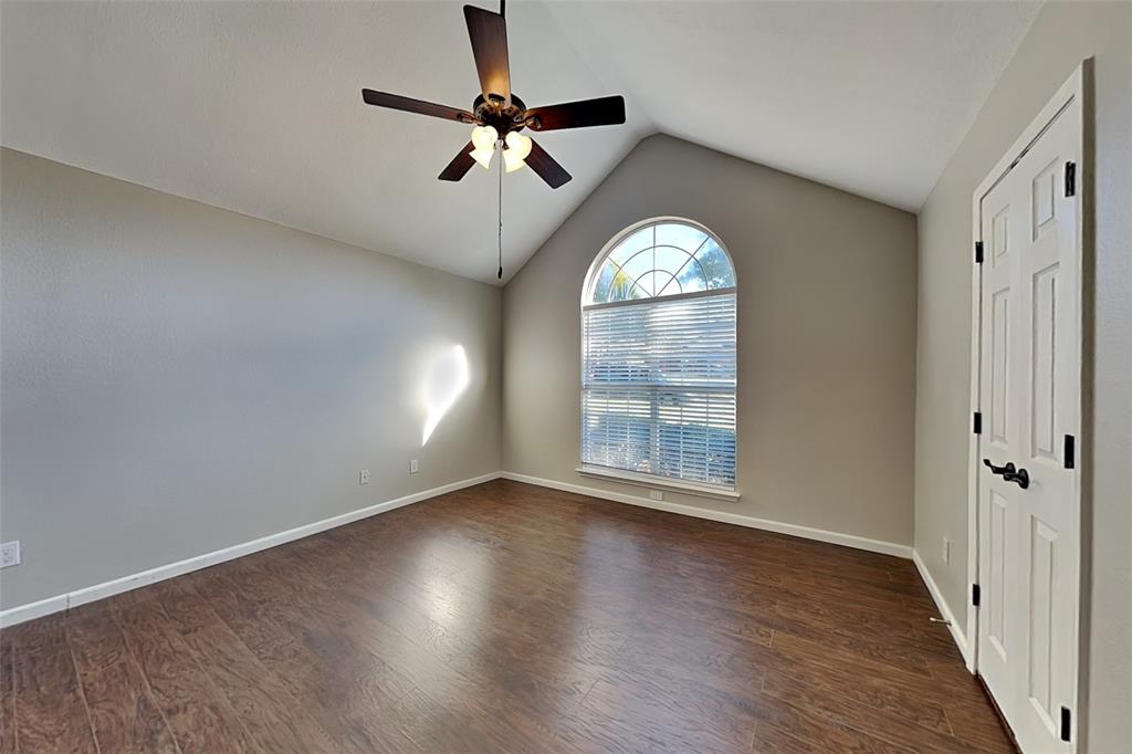 7641 Lancelot Road Frisco, TX 75035 - Photo 8 of 21 an empty room with wooden floor fan and windows
