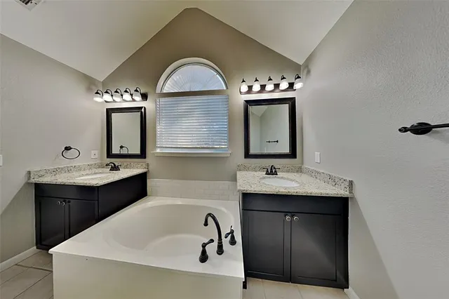 a bathroom with a double vanity sink and mirror