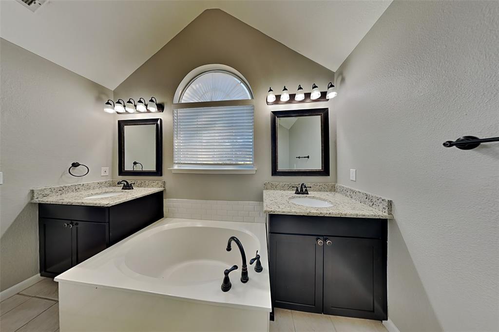 7641 Lancelot Road Frisco, TX 75035 - Photo 10 of 21 a bathroom with a double vanity sink and mirror