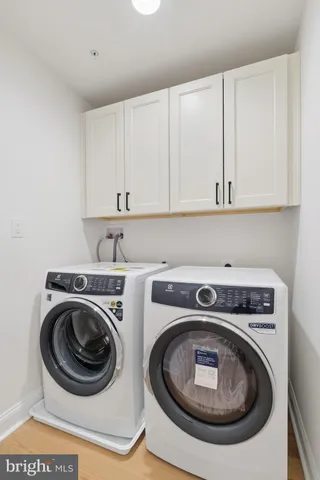 a utility room with sink dryer and washer