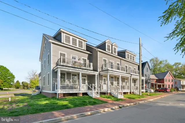 a front view of a building with a garden
