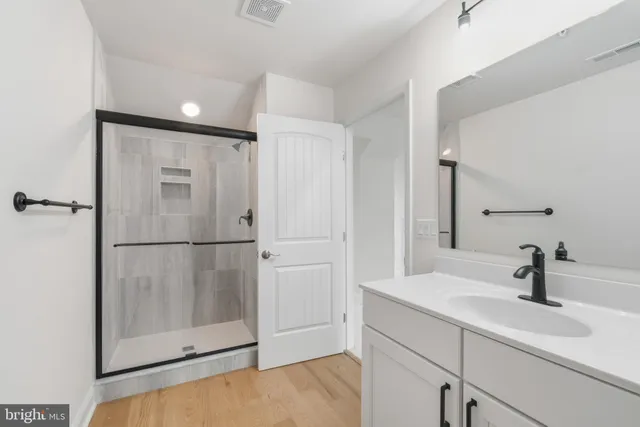 a bathroom with a double vanity sink and mirror
