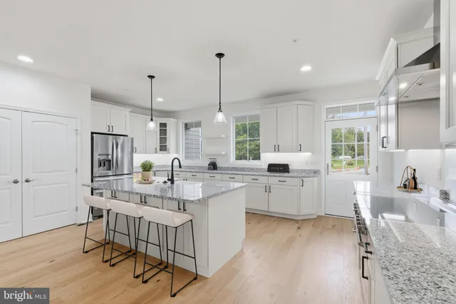 a kitchen with sink cabinets and wooden floor