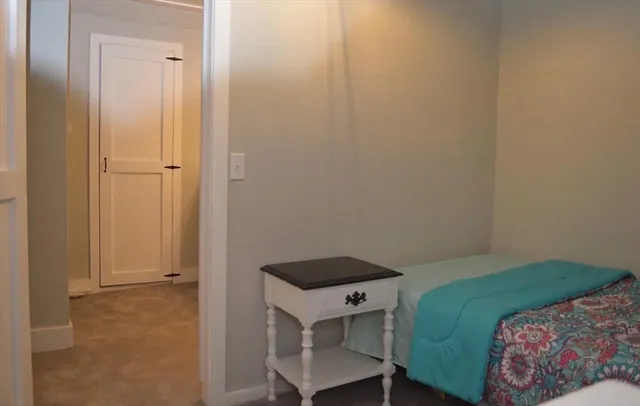 a bedroom with a bed and a cabinet