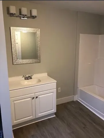 a bathroom with a sink a toilet and vanity