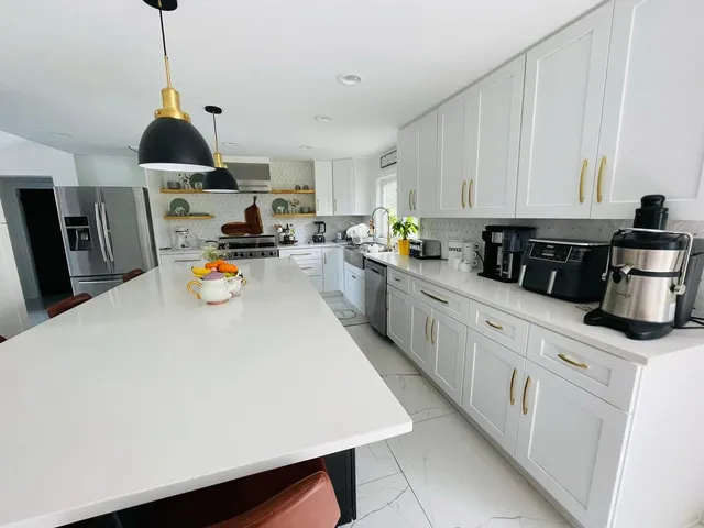 a kitchen with a sink a stove and cabinets