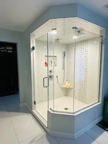 a bathroom with a glass shower door and a bathtub