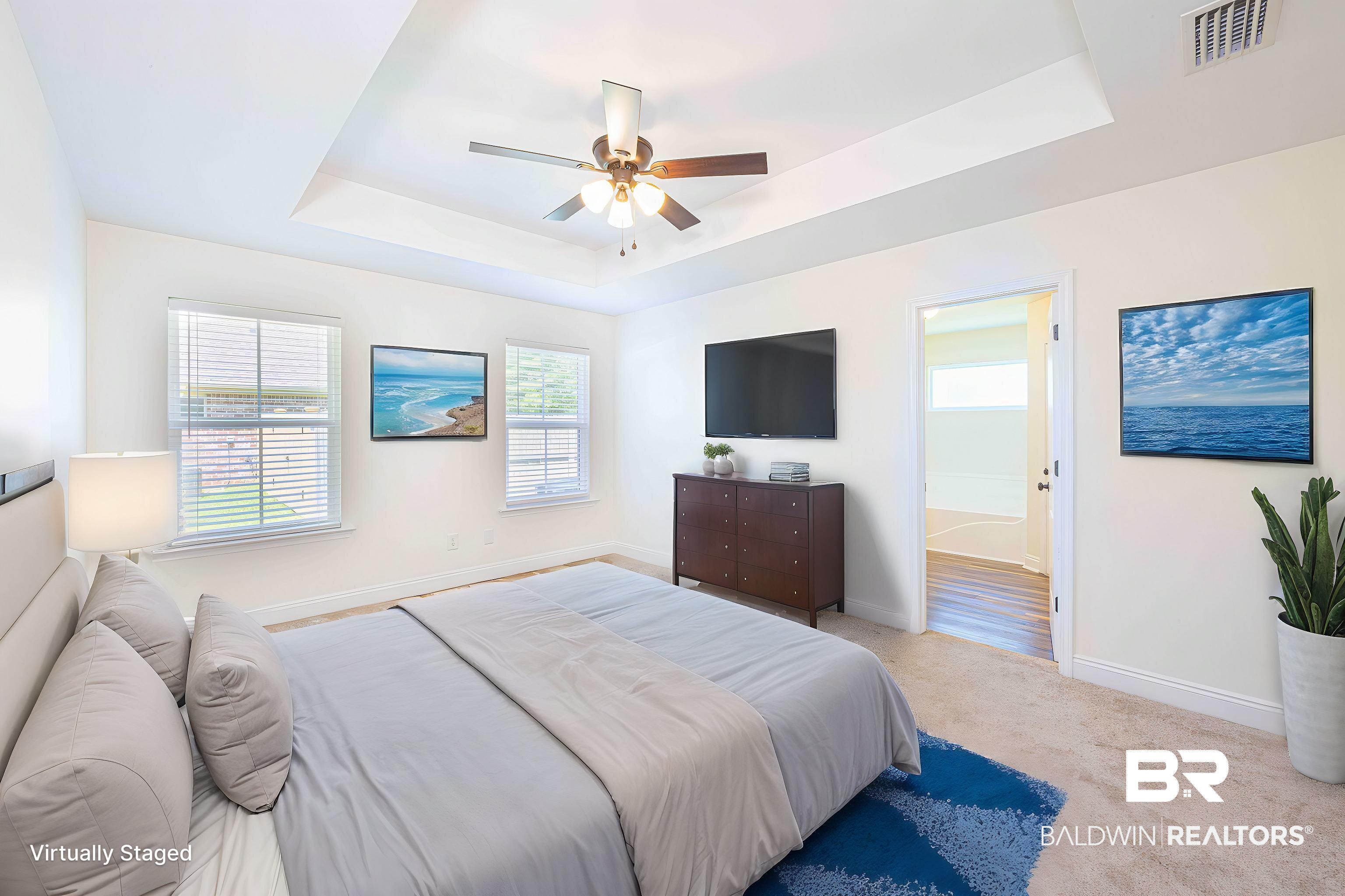 18675 Explorer Drive Loxley, AL 36551 - Photo 18 of 42 Bedroom featuring a raised ceiling, baseboards, carpet, and connected bathroom