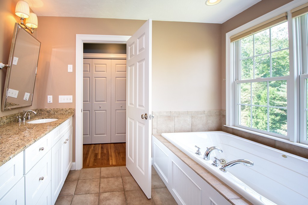 123 Tilden Road Scituate, MA 02066 - Photo 15 of 27 a bathroom with a granite countertop sink and a bathtub