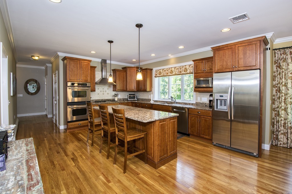 123 Tilden Road Scituate, MA 02066 - Photo 2 of 27 a kitchen with stainless steel appliances granite countertop a refrigerator a stove top oven a sink dishwasher and white cabinets with wooden floor