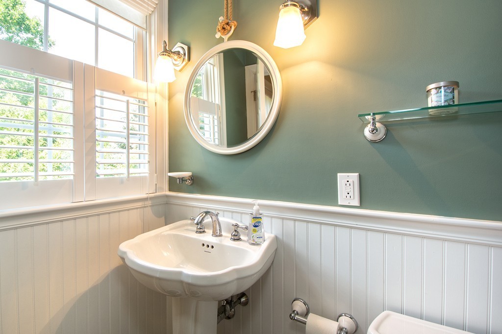 123 Tilden Road Scituate, MA 02066 - Photo 21 of 27 a bathroom with a sink a mirror and a window