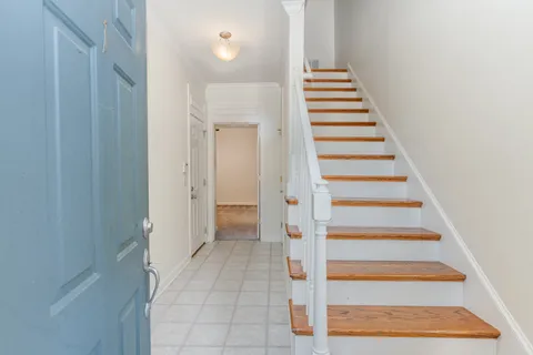 a view of entryway and hall with wooden floor