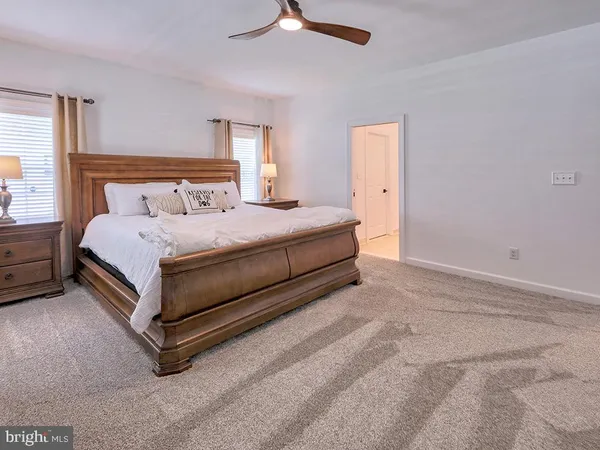 a bedroom with a bed and a ceiling fan