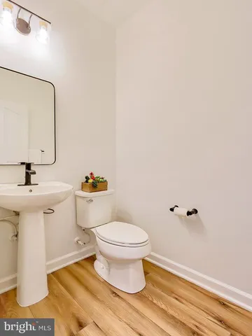 a bathroom with a sink toilet and a mirror