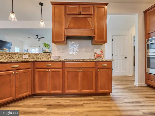 a kitchen with granite countertop wooden cabinets and a sink
