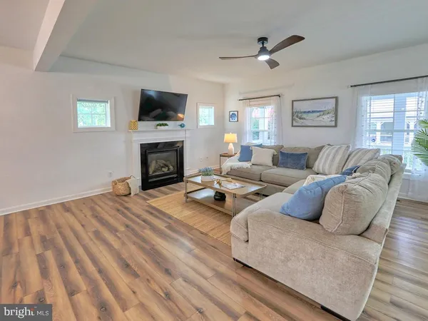 a living room with furniture fireplace and flat screen tv