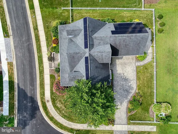 an aerial view of a house with swimming pool garden and patio