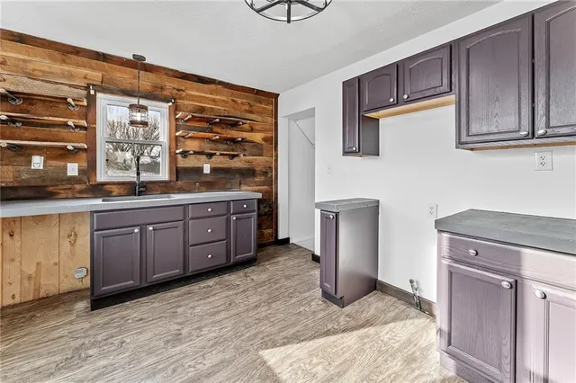 a kitchen with stainless steel appliances granite countertop a sink and cabinets