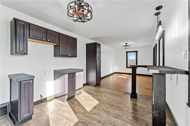 a view of a livingroom with furniture hardwood floor and a ceiling fan