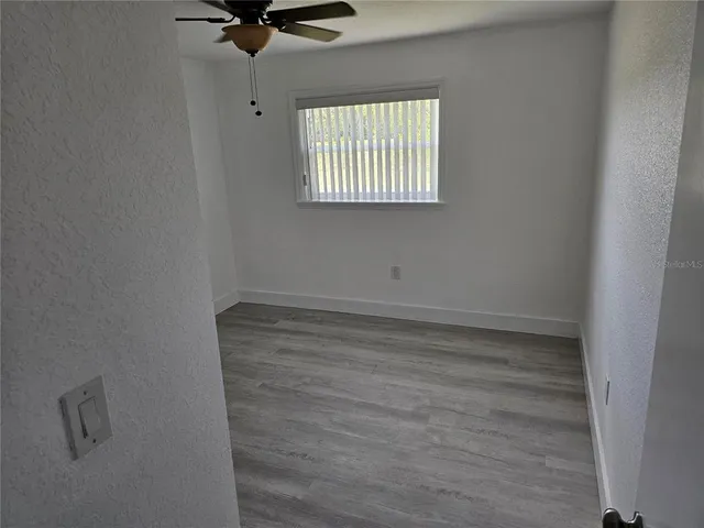 a room with a window and a ceiling fan
