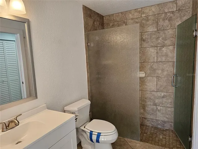 a bathroom with a sink a toilet and a shower
