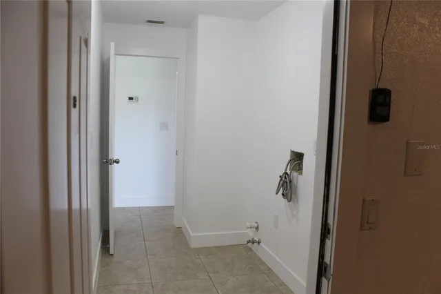 a white wall with a close up view of a utility room