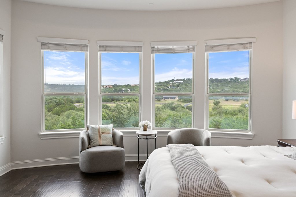 215 Lodestone Lane Austin, TX 78738 - Photo 7 of 40 Unobstructed scenic views provide a tranquil backdrop for this inviting primary bedroom.