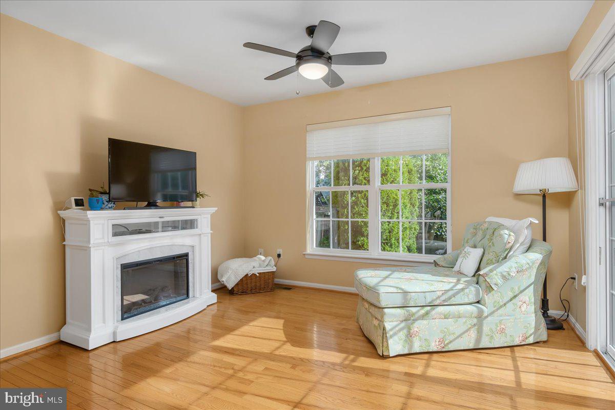 2003 Buell Drive Frederick, MD 21702 - Photo 9 of 32 a living room with a fireplace furniture a flat screen tv and a large window