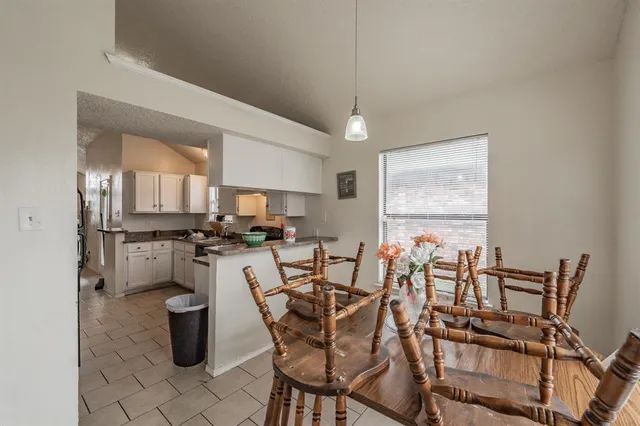 a view of a dining room with furniture and a chandelier