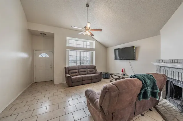 a living room with furniture a chandelier and a flat screen tv